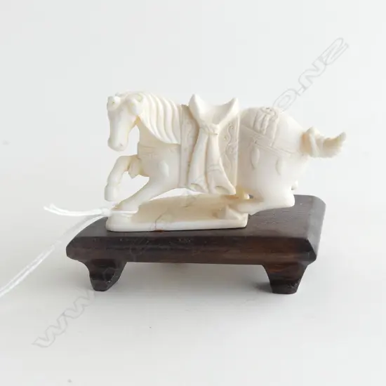 CARVED IVORY SITTING HORSE ON WOODEN STAND L 80MM