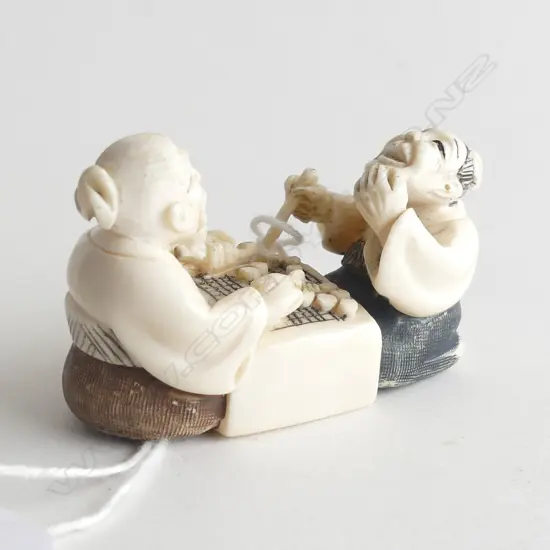 FINELY CARVED IVORY NETSUKE; 2 MEN PLAYING MAHJONG L 50MM