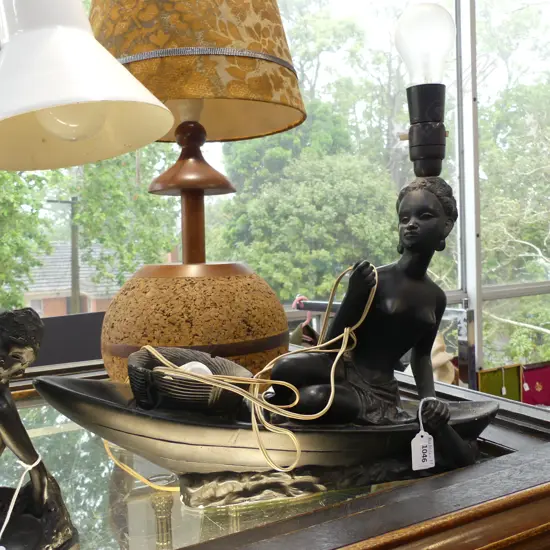 LG TABLE LAMP - NAKED BLACK LADY IN RAFT - MISSING OAR & DAMAGE TO END OF RAFT L 500MM