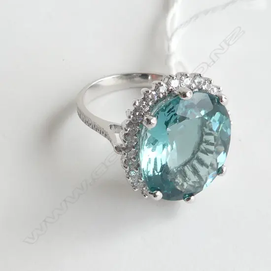 SILVER RING WITH TOPAZ STYLE STONE AND CZs, SIZE O