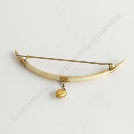 TUSK? PIN WITH GOLD FITTINGS AND SUSPENDED HEART