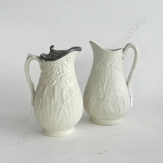 2 PARIAN WARE JUGS WITH WHEATSHEAF EMBOSSED DESIGNS, ONE HAS A PEWTER LID, (H.230 & 240mm)