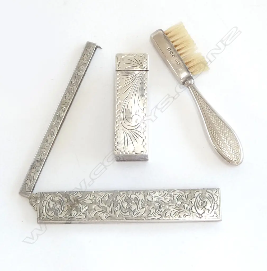 A silver handled toothbrush, a silver comb case and an 800 silver lipstick case with sprung mirror. Image 1++