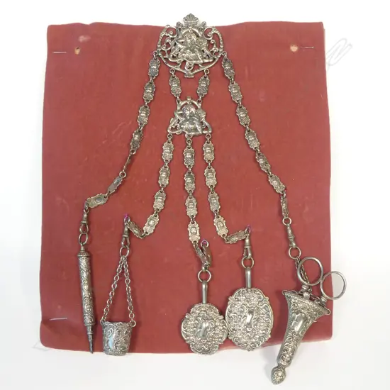 A late 19thC Art Nouveau silver plate chatelaine with five suspended objects,