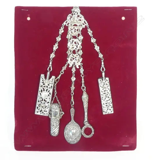A rococo design sterling silver chatelaine with five suspended accoutrements, hallmarked London 1888 by Rosenthal, Jacob & Co (Julius Rosenthal & Samuel Jacob),