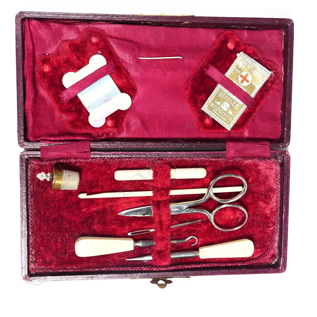 A red morocco cased sewing kit, with bone handled implements Image 1++