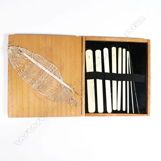 A box of bone netting tools, and two steel netting shuttles.