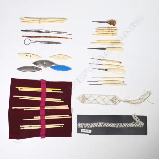 A collection of bone tatting shuttles, bone handled tambour hooks and stilettos, bone crochet hooks and other tools.