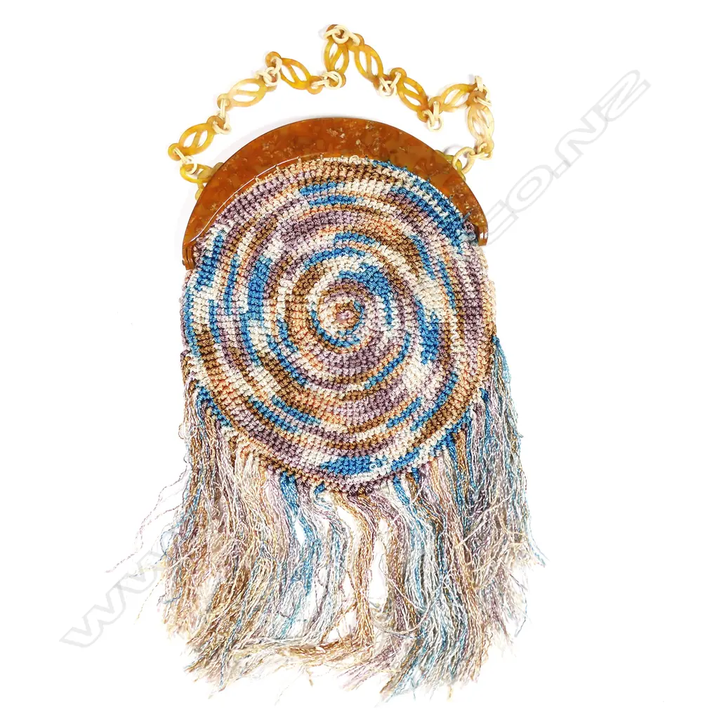 A French Art Deco period crocheted silk handbag with mottled amber plastic frame, Image 1++