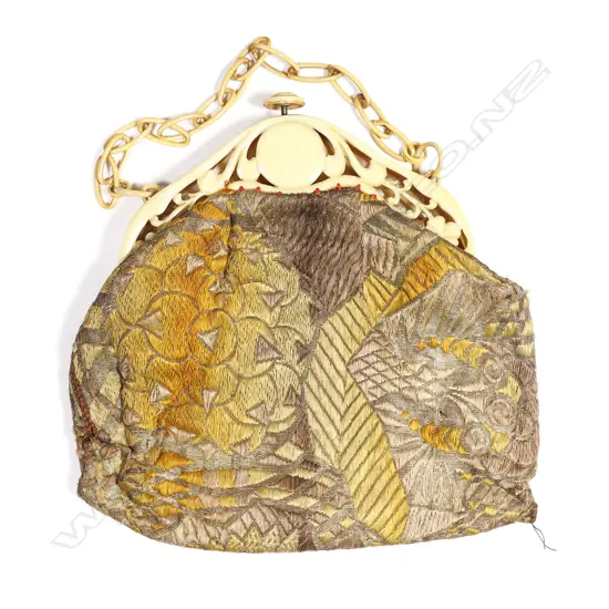 A French Art Deco period handbag with pierced ivorine plastic frame,