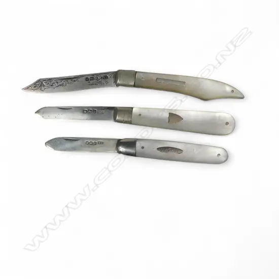 Three mother of pearl handled folding sterling silver bladed fruit knives, one of uncommon clipped shape. Various dates and makers.