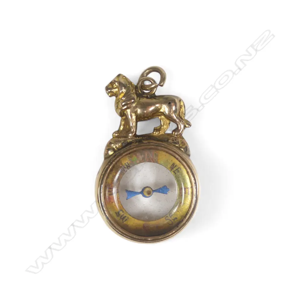 A Victorian 9ct gold fob, as a lion passant surmounting a small glazed double sided compass. Birmingham 1893. Approx 5.6gms total Image 1++