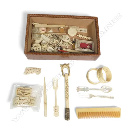 Faux snakeskin box containing an assortment of small ivory pieces, some damaged, some incomplete, along with an ivorine parasol handle