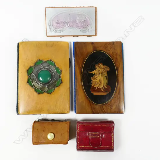Two fruitwood faced needle books and two miniature leather sewing kits and a Nouveau needle holder,