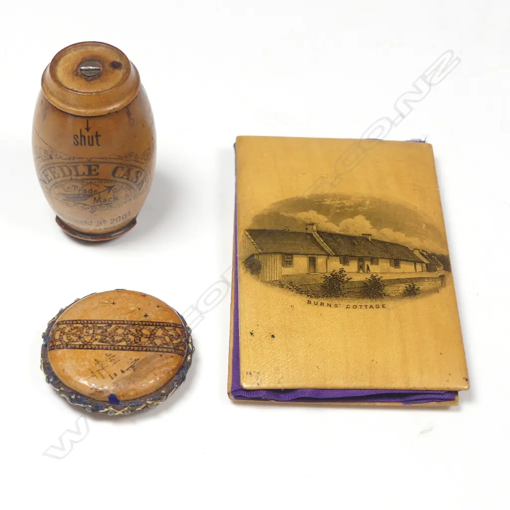 A Mauchlin ware needle book, a German fruitwood needle cask, and a souvenir pincushion, Image 1++