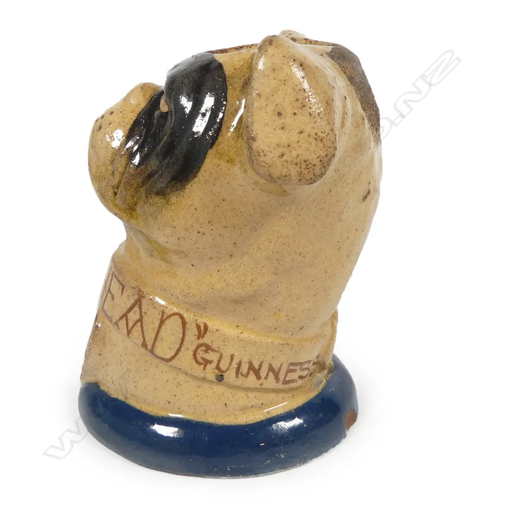 An early 20thC glazed pottery 'Dog's Head' wax vesta match holder in the form of a boxer dog advertising 'Guinness' and 'Bass', Image 1++