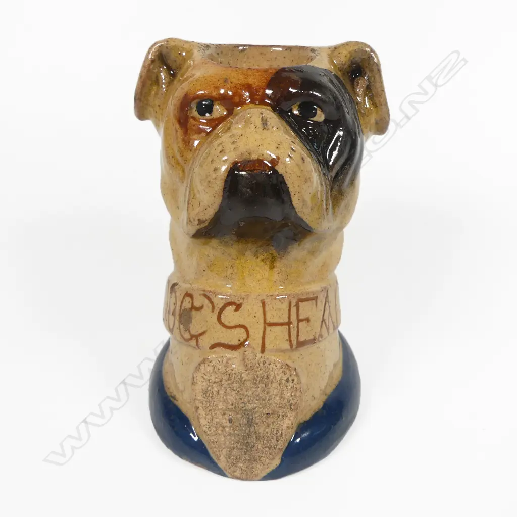 An early 20thC glazed pottery 'Dog's Head' wax vesta match holder in the form of a boxer dog advertising 'Guinness' and 'Bass', Image 1++