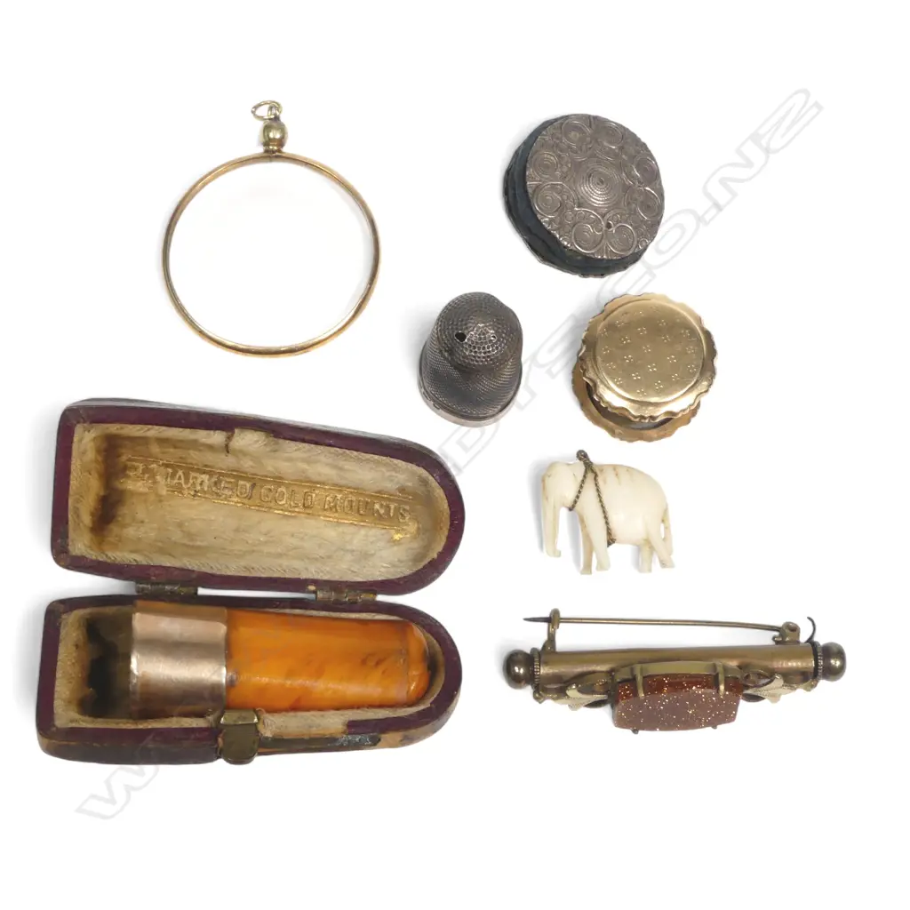 9ct gold framed circular glass pendant; gold mounted amber cigar holder; Dutch gold bobbin holding sewing wax; silver size 15 thimble; plated disc pincushion; a goldstone set gilt 'nanny brooch', Image 1++