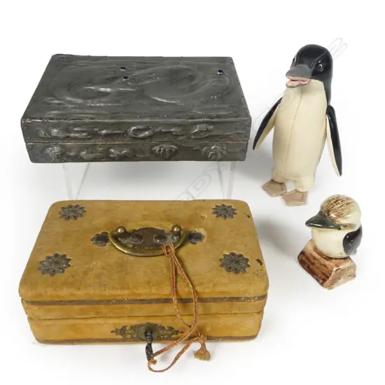 An embossed pewter Arts & Crafts style cigarette box; a microscopically inscribed grain of rice curio; a Japanese Tomi leather penguin and a Grace Seecombe kookaburra salt shaker.