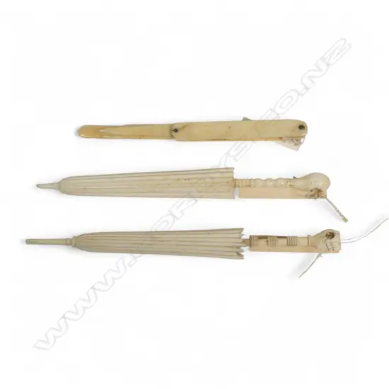 Three bone Stanhopes (lacking the views) - two of parasol shaped needle cases and a folding manicure implement.