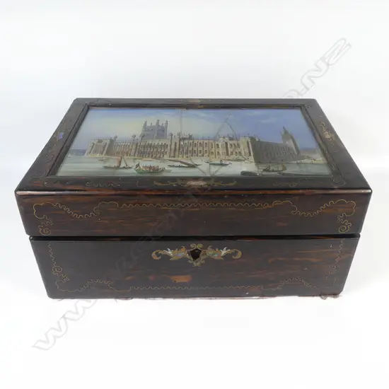 A Victorian ebony grained work box with glass reverse print inset top, (glass faulted), interior fitted with Mother of pearl handled implements and with original owner's details. W.305mm