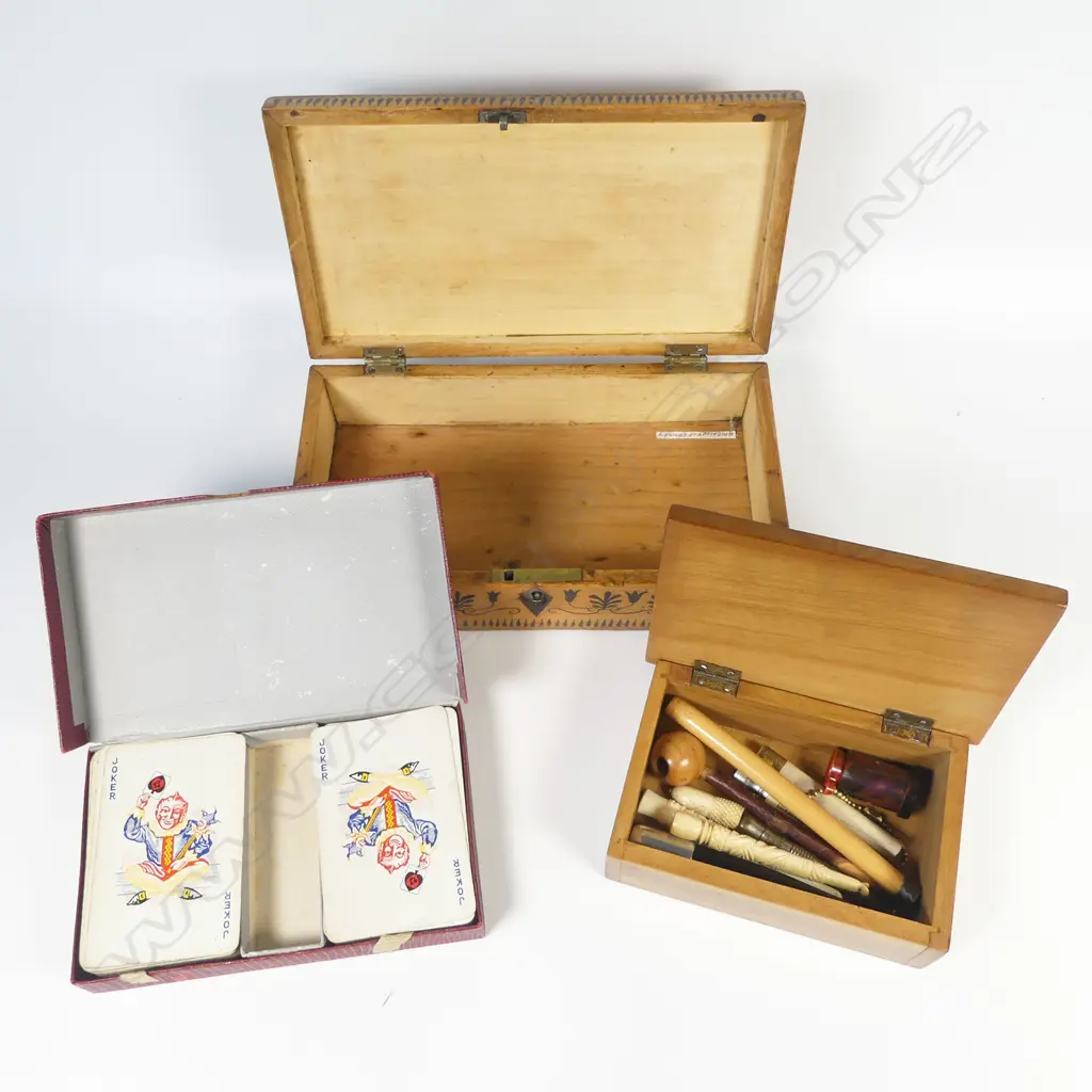 Small wooden box containing cigar piercers, bone cigarette holders and risqué monocular viewer. With a pen-work decorated box and set of Thomas de la Rue 'Pneumatic' playing cards Image 1++