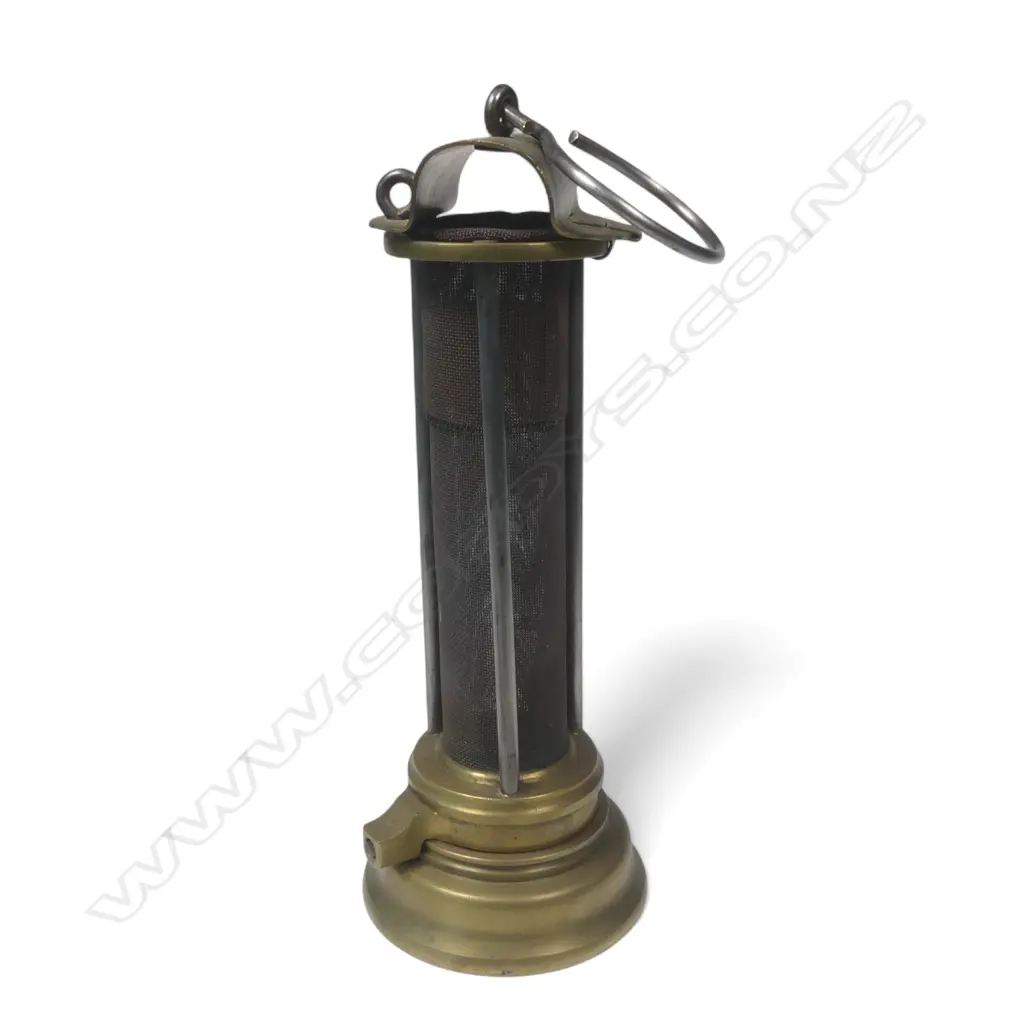 A miner's brass Safety Lamp, c.1900 Thomas & Williams style. The body being a long gauze section protected by three bars. H.235mm. Image 1++