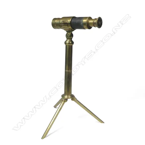 An interesting small three draw telescope (6" closed), fitted to a brass column and tripod base,