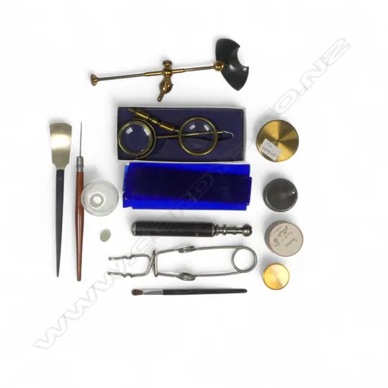 A selection of microscope slide preparation instruments, blue glass slides, covers, bullseyes, etc.