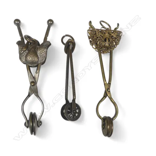 Three Victorian period skirt lifters / holders, marked Fyfe's Patent and 'The Eureka' Bancroft Bros.,