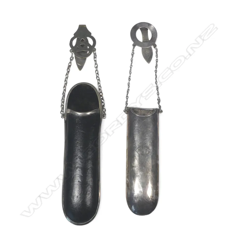 Two spectacle chatelaines, one sliver plate with sterling silver hanger, the other black leather with plated hanger Image 1++