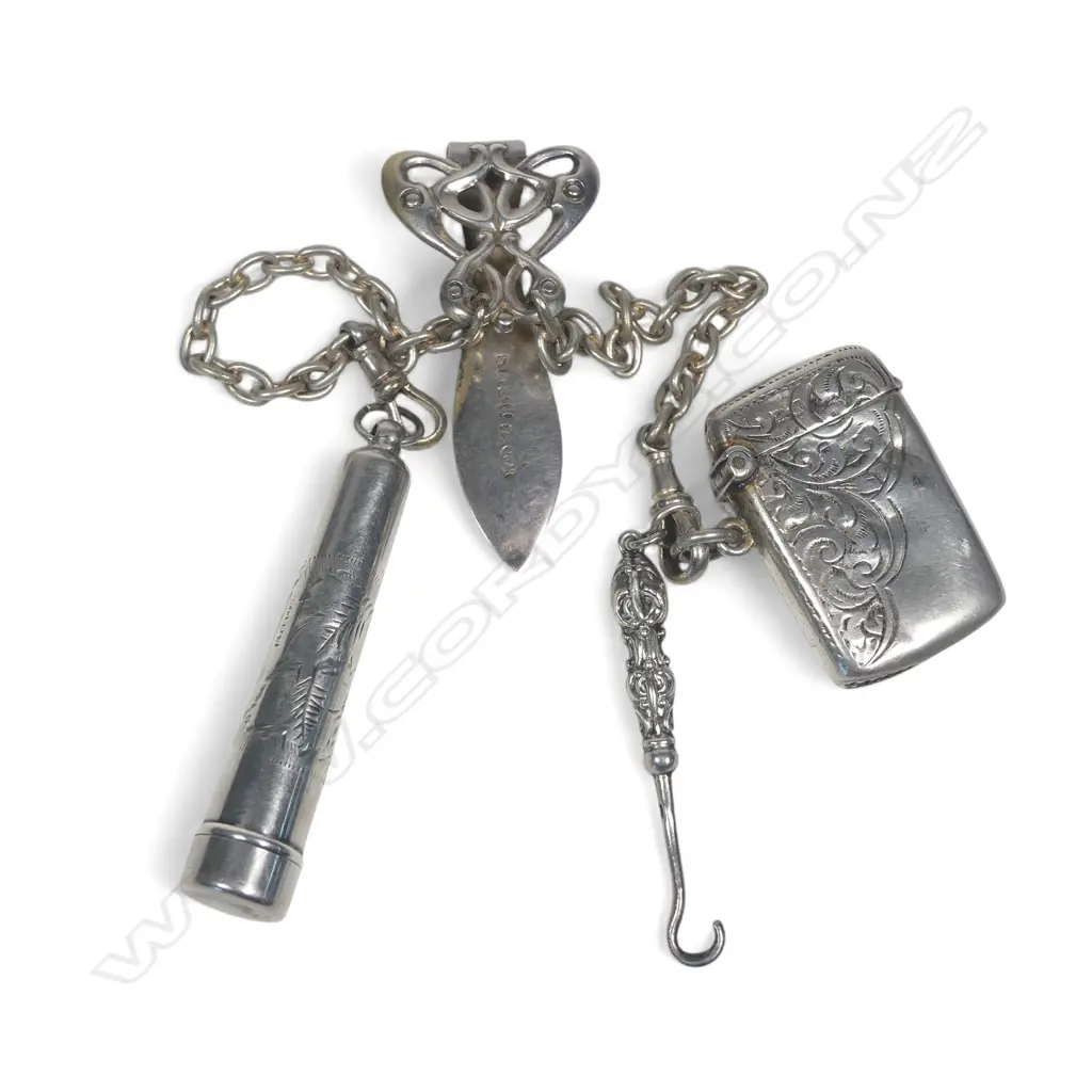 Art Nouveau silver plate double chain chatelaine with sterling silver seal button hook, small vesta and case containing an amber and silver cigarette holder. Image 1++