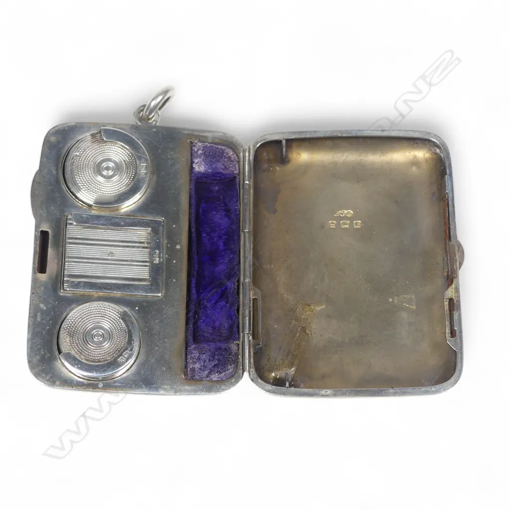 An Edwardian silver combination cigarette case fitted with sovereign and half-sovereign sprung silo holders,  a sprung stamp holder and a space for a small cigarette holder. Image 1++