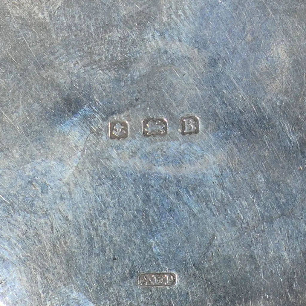 A late Victorian sterling silver notepad with four ivorine leaves, Birmingham 1899 by Lawrence Emanuel, on silver plate albertina; along with a sterling silver compact Birmingham 1926 by A.L. Denninson, mirror inside lid, press fitting frame to hold commercial powder cakes. Image 1++