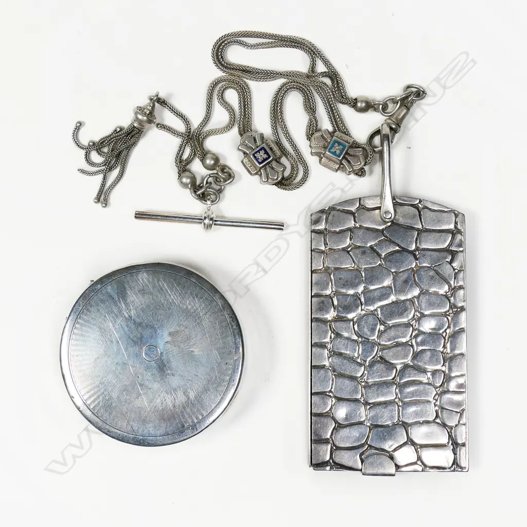 A late Victorian sterling silver notepad with four ivorine leaves, Birmingham 1899 by Lawrence Emanuel, on silver plate albertina; along with a sterling silver compact Birmingham 1926 by A.L. Denninson, mirror inside lid, press fitting frame to hold commercial powder cakes. Image 1++