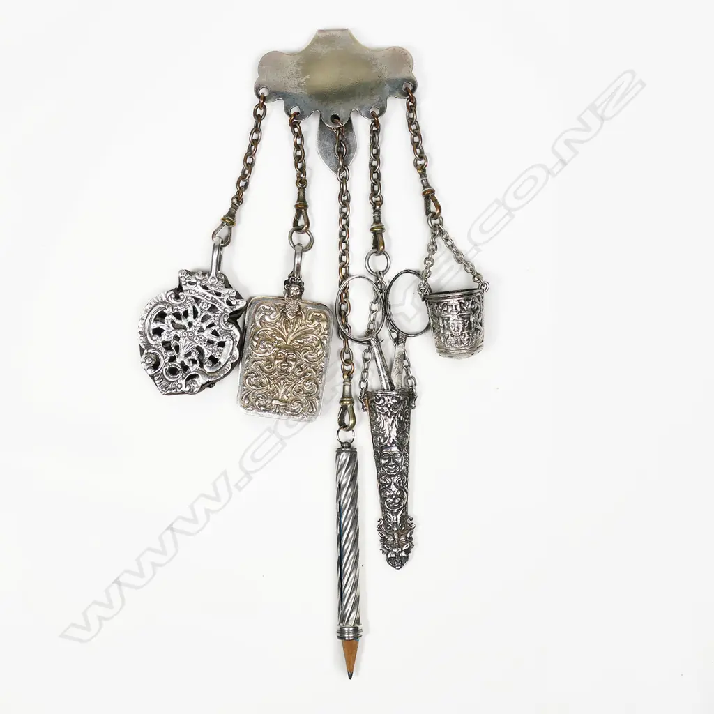 An silver plate chatelaine with ornate silver pincushion and wrythen pencil holder, and three other ornate silver plate implements, Image 1++