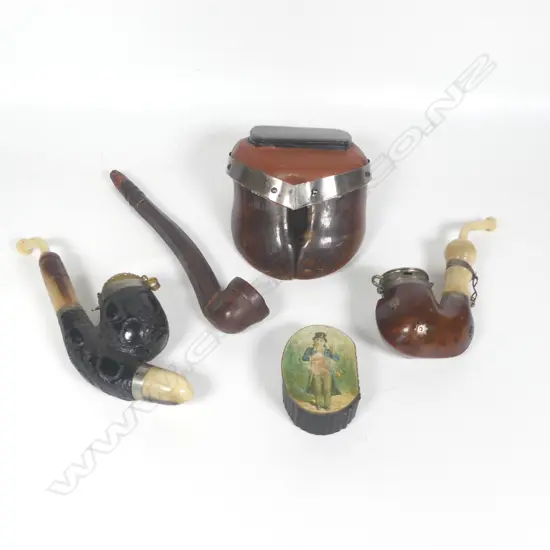 Two European tobacco pipes, a ceramic tobacco pipe, a snuff box mounted to an ox's hoof, and a small decoupage topped snuff box.