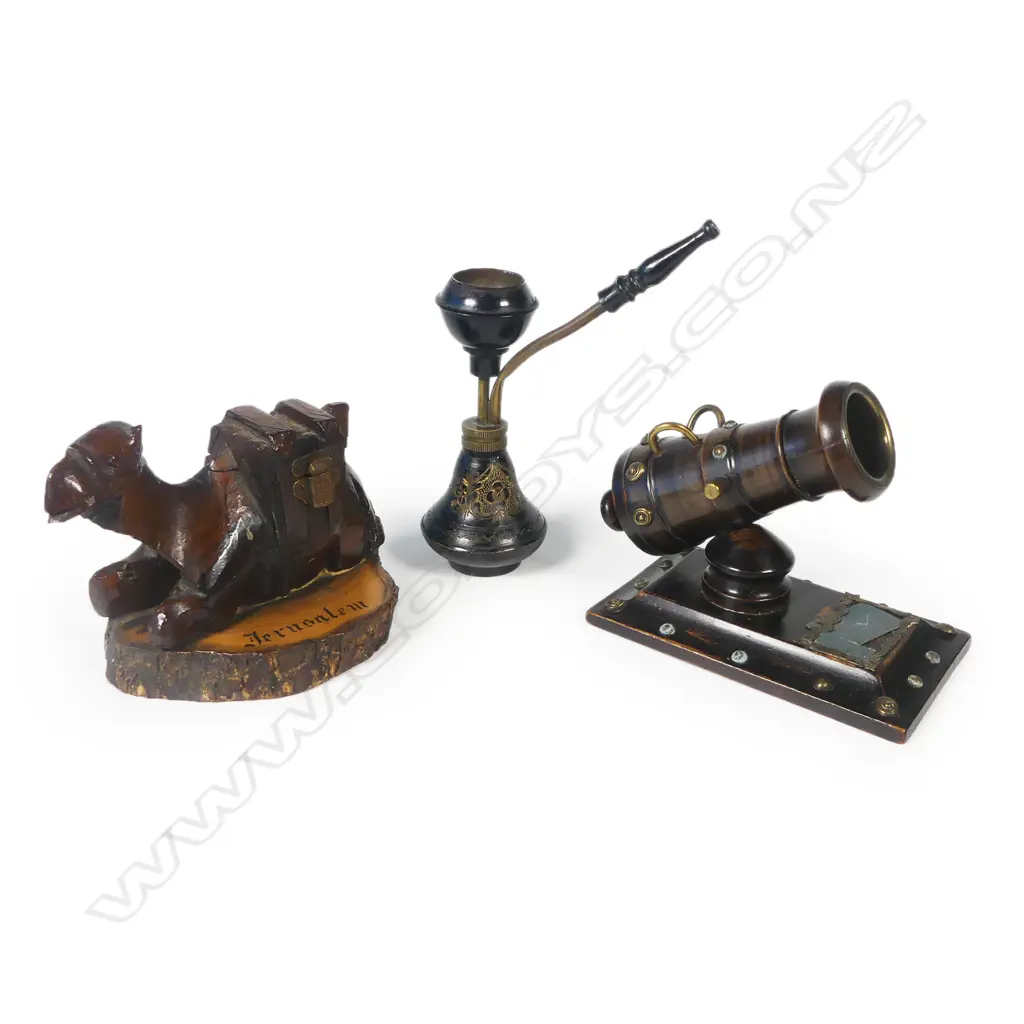 A novelty vesta modelled as a mortar cannon, a small brass hookhah pipe, and a carved olive wood camel souvenir of Jerusalem whose saddle opens to reveal a small inkwell. Camel L.120mm Image 1++