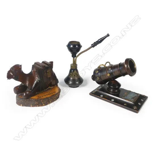 A novelty vesta modelled as a mortar cannon, a small brass hookah pipe, and a carved olive wood camel souvenir of Jerusalem whose saddle opens to reveal a small inkwell. Camel L.120mm