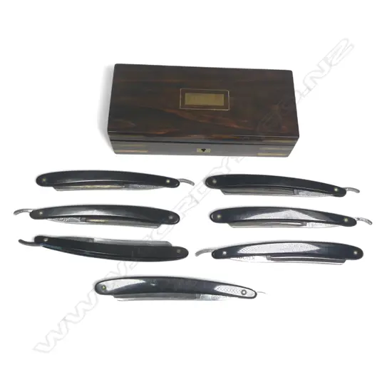 A set of seven Kropp cut throat razors, the blade spines etched with days of the week, in fine rosewood presentation case with brass corner strapping and escutcheon to the hinged lid,