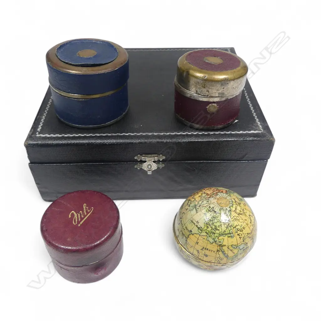 Four travelling inkwells, including one formed as a world globe, of gilt metal overlaid with lithographed paper gores printed in German language, 1900. Dia.50mm. Image 1++