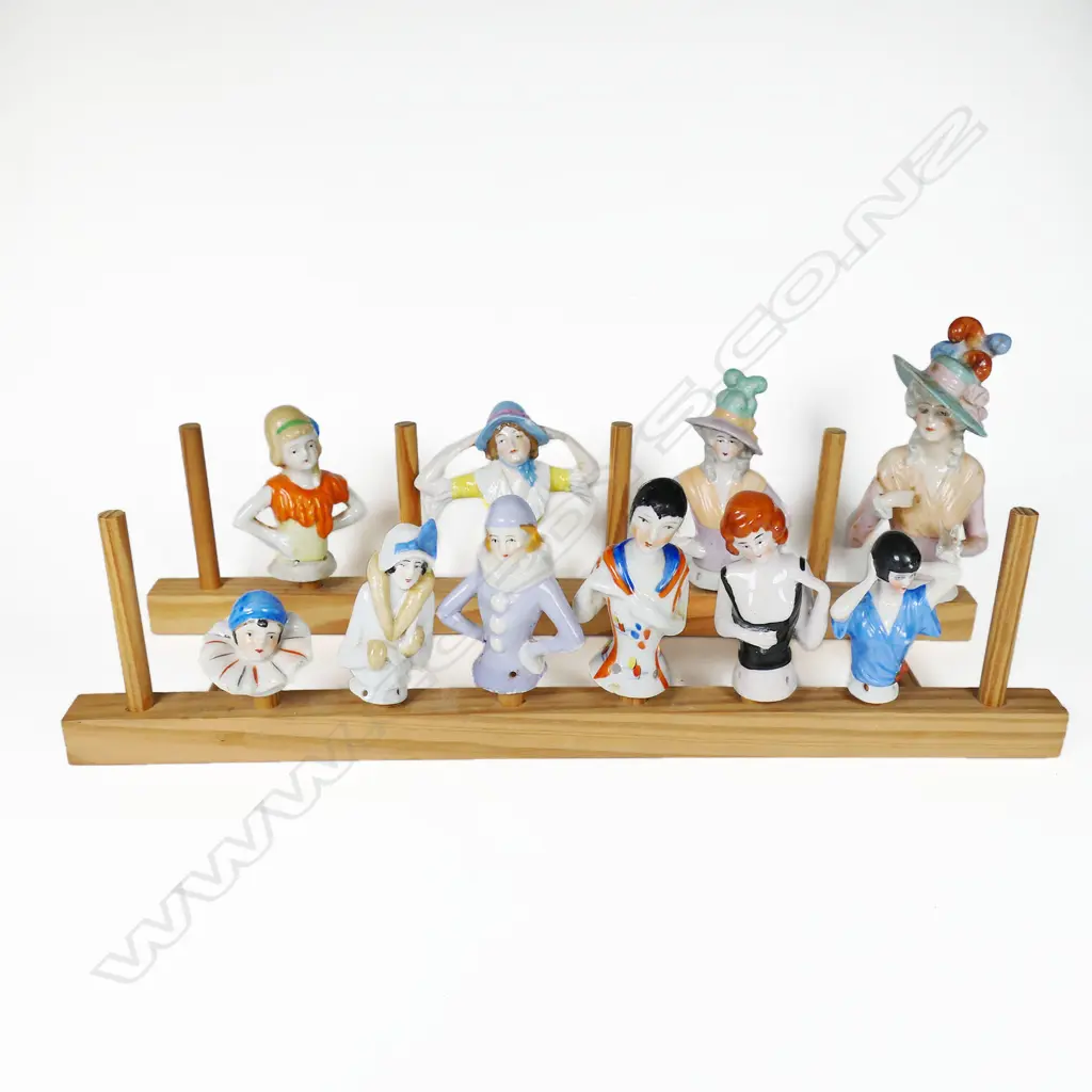 A collection of ten porcelain half-dolls, of various sizes, the largest with faults. Image 1++