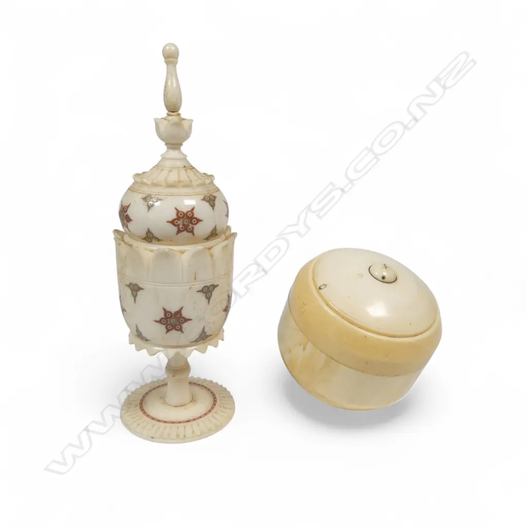 A turned solid ivory two-piece box of rounded shape, and an Indian turned bone urn on pedestal foot decorated with coloured circle cut designs. H.140mm Image 1++