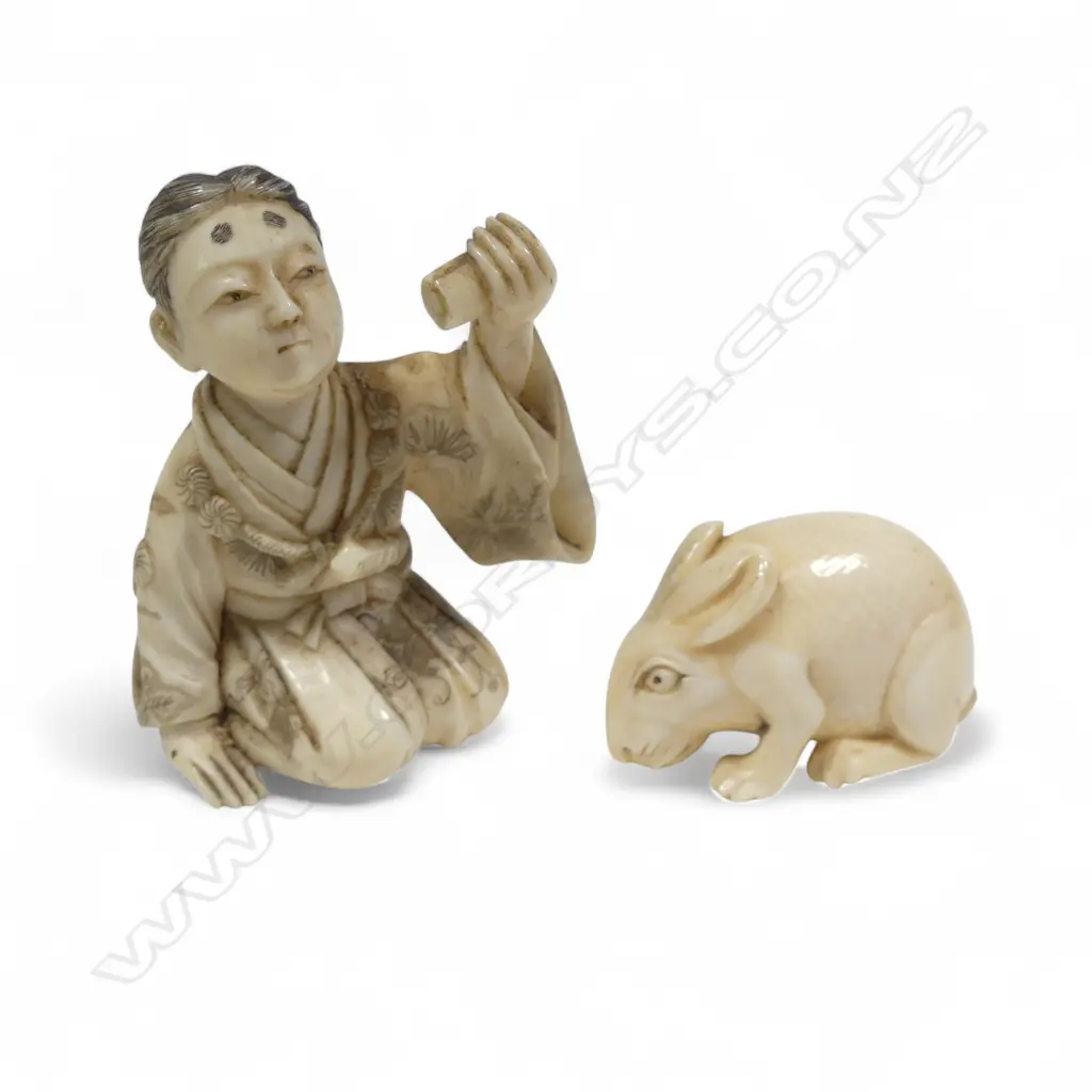 Two Japanese ivory carvings - an small okimono of a samurai kneeling whilst proffering a scroll (some losses), and a compact netsuke of a crouching rabbit. Image 1++
