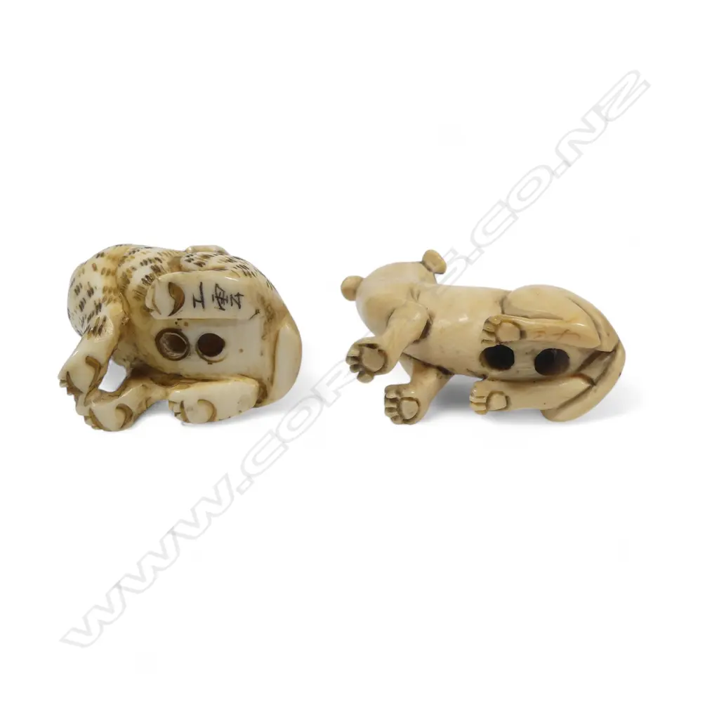 Two small Japanese ivory netsuke - a spotted dog with pup climbing its haunches; an a seated dog. Image 1++