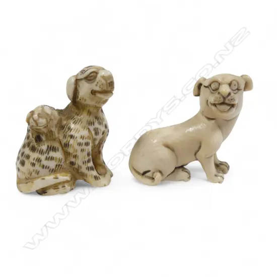 Two small Japanese ivory netsuke - a spotted dog with pup climbing its haunches; and a seated dog.