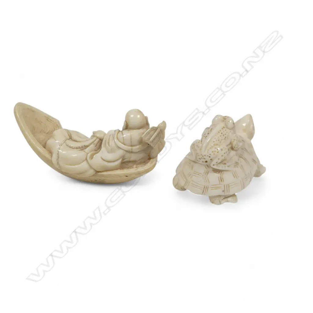 Two small Japanese ivory netsuke - Hotei with treasure sack adrift in a boat (AF), and a frog riding on the back of a tortoise. Both signed. Image 1++