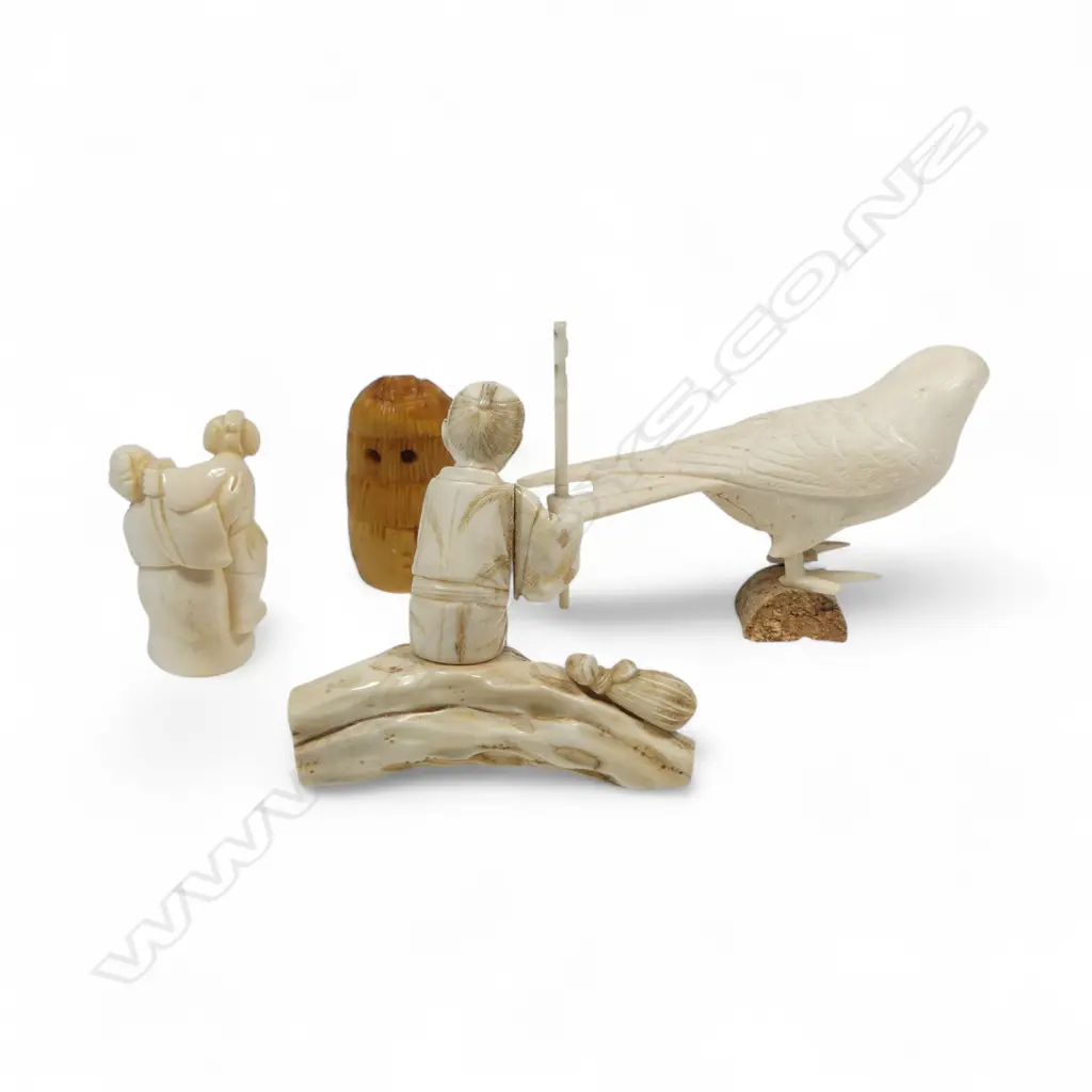 A sectional ivory okimono of a swallow, (nerve hollowed out and one end unplugged); a sectional okimono of a man with tame bird (detail absent from pole in right hand); ivory kimono of a couple and a numeric stained tooth ivory netsuke. Image 1++