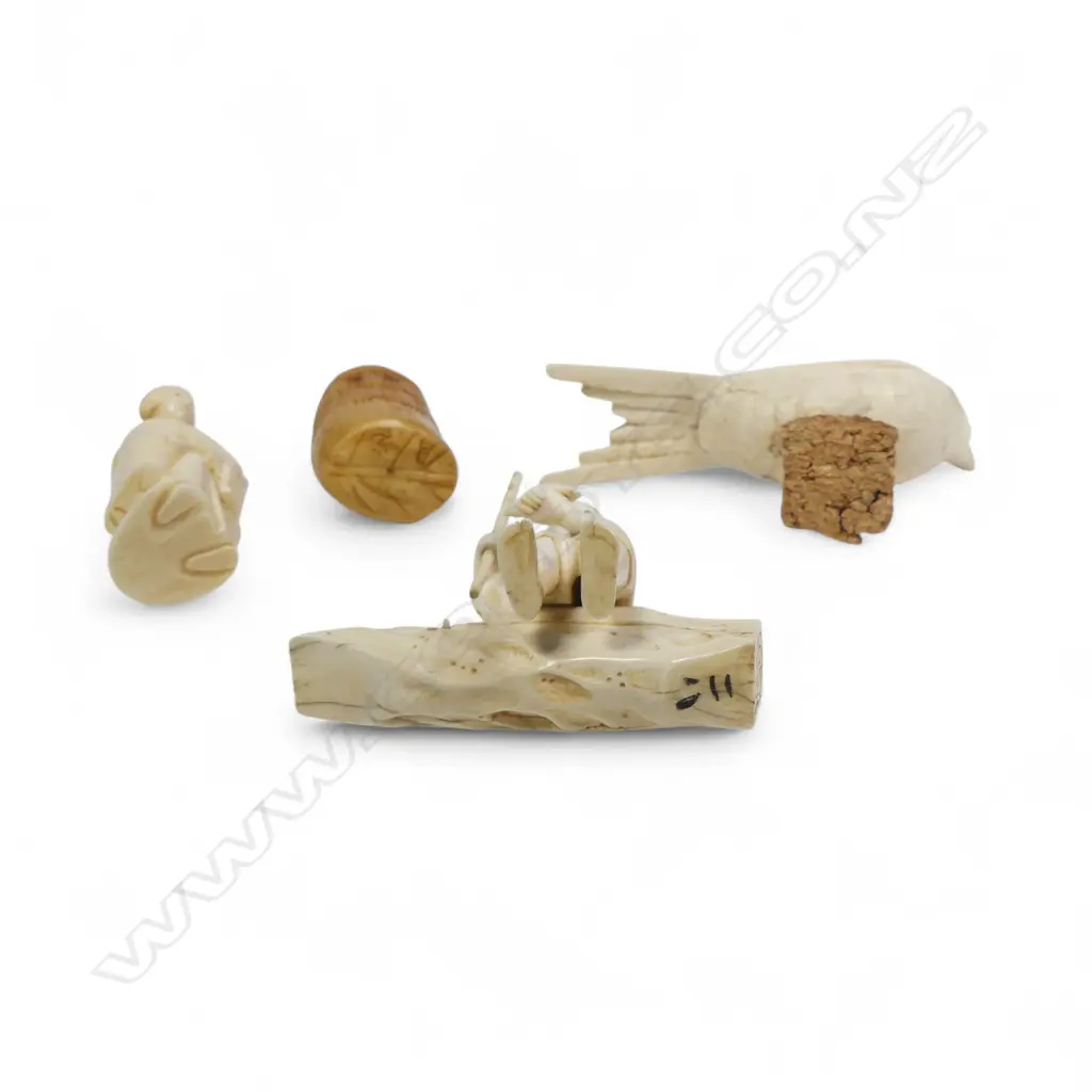 A sectional ivory okimono of a swallow, (nerve hollowed out and one end unplugged); a sectional okimono of a man with tame bird (detail absent from pole in right hand); ivory kimono of a couple and a numeric stained tooth ivory netsuke. Image 1++