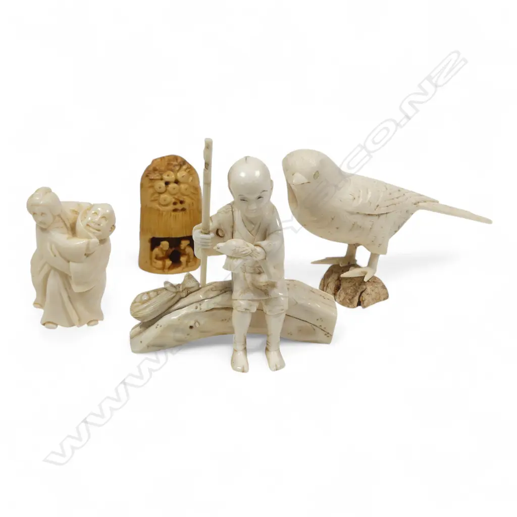 A sectional ivory okimono of a swallow, (nerve hollowed out and one end unplugged); a sectional okimono of a man with tame bird (detail absent from pole in right hand); ivory kimono of a couple and a numeric stained tooth ivory netsuke. Image 1++